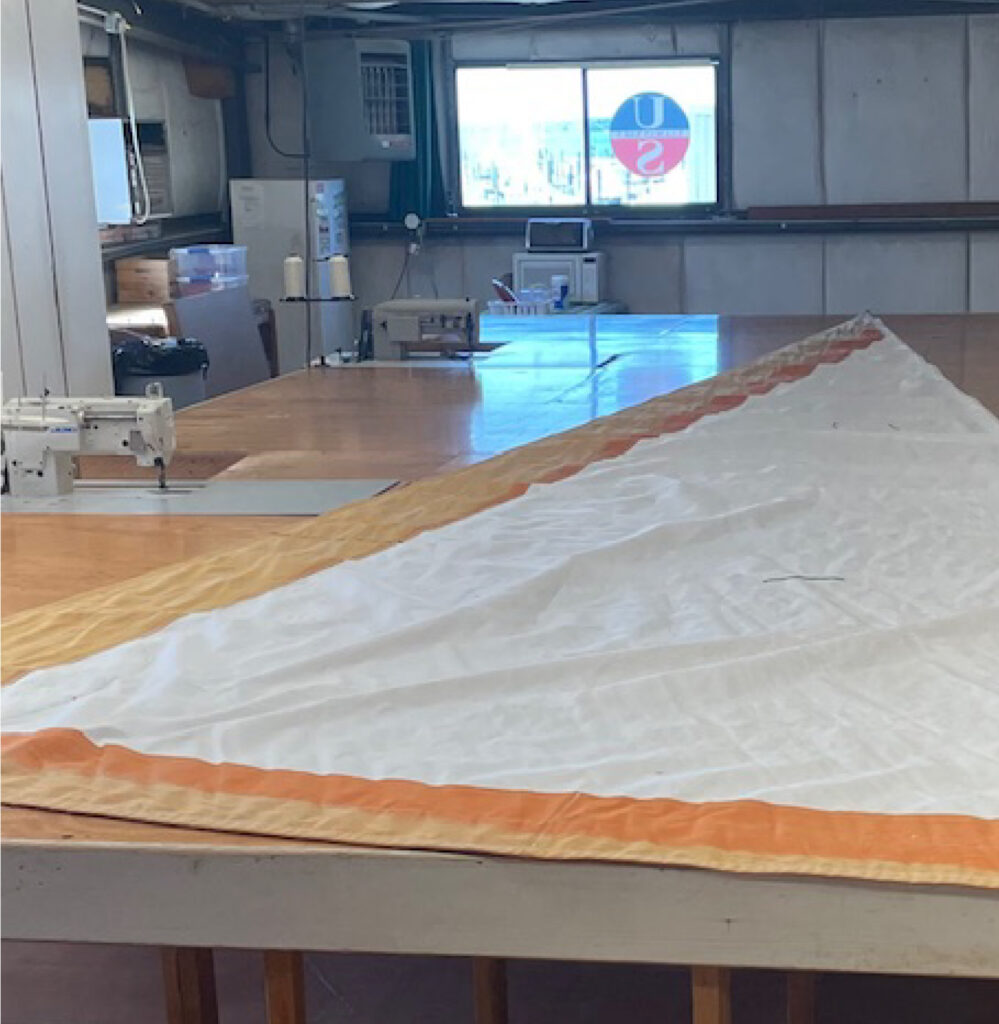 To make your sails last longer, start with smart protection—like reinforced UV edging, ready for inspection right here in the loft.