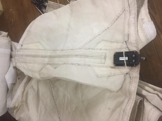 Old sail to be replaced showing batten pocket details and hardware.