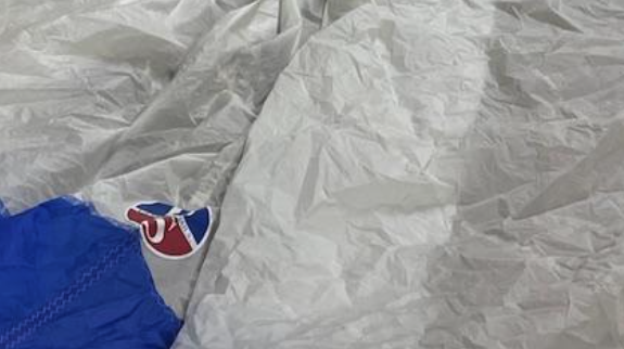 Spinnaker being repaired on the loft floor